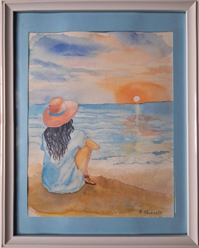 Acquerello che ritrae una ragazza in spiaggia osservando un tramonto di Anna Maria Chiarelli. Opera esposta alla mostra 'Parole d’arte e Creatività' per il Salone Off 2026 dell'Associazione Gli Artimani APS."